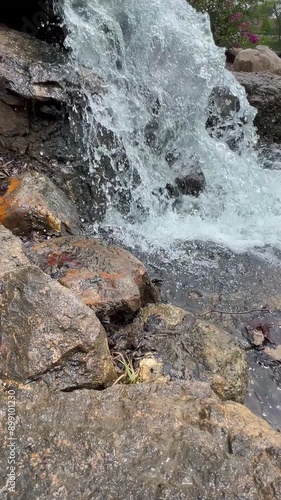 Waterfall cascading splashing brown gray stones natural bubbling hardscape background