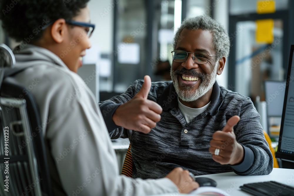 Smiling elderly man with gray hair giving a thumbs up in a modern office setting. Smiling elderly man with gray hair giving a thumbs up in a modern office setting.