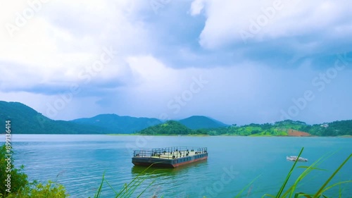 A boat in the lake, big hills around the lake are beautiful natural background