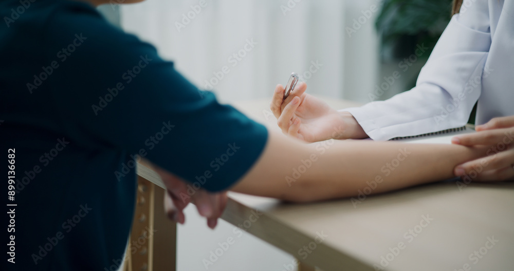 Selective focus hands of Asian doctor examines sore arm and give advice of young female patient in clinic office, Health and medicine consultant, conversation about healthcare Selective focus hands of Asian doctor examines sore arm and give advice of young female patient in clinic office, Health and medicine consultant, conversation about healthcare