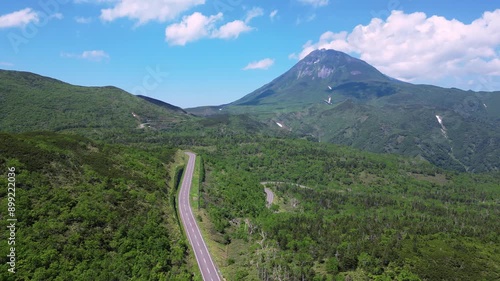 Rausu, Hokkaido: Aerial drone footage of the Shiretoko pass road with the Mt Rausu volcano in the Shiretoko peninsula between Utoro and Rausu town on a sunny summer day in Japan. photo