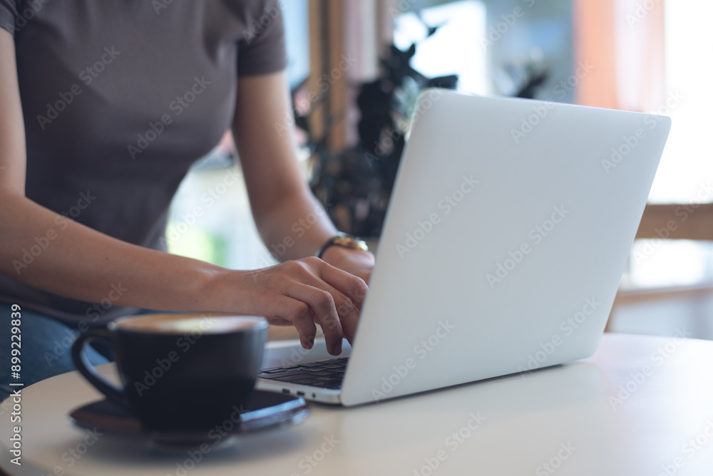 Woman working on laptop computer in coffee shop, freelance at work, people lifestyle. Business woman in csual wear online working on laptop, surfing the internet at, cafe, remote work Woman working on laptop computer in coffee shop, freelance at work, people lifestyle. Business woman in csual wear online working on laptop, surfing the internet at, cafe, remote work