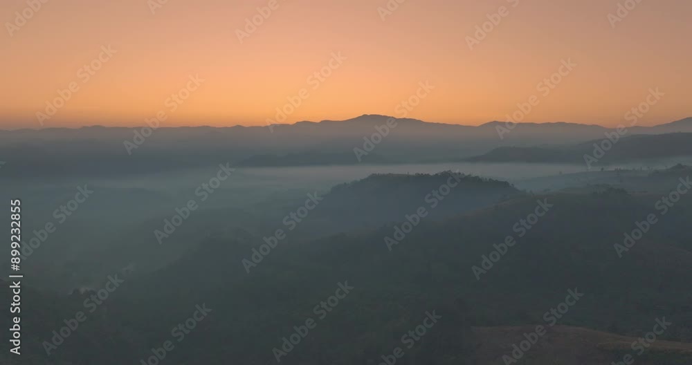 Aerial view A breathtaking view of dawn breaking over a misty mountain landscape, with layers of fog and vibrant colors painting the horizon. The serene atmosphere and natural beauty Aerial view A breathtaking view of dawn breaking over a misty mountain landscape, with layers of fog and vibrant colors painting the horizon. The serene atmosphere and natural beauty