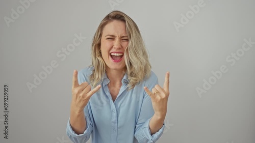 Wallpaper Mural Crazy beautiful blonde rock star, young woman strikes a wild, heavy metal expression, wearing shirt, hand signs flying, on a stark white isolated background! Torontodigital.ca