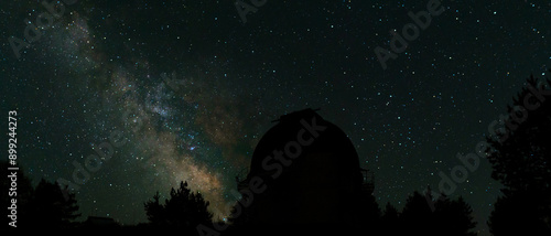 Photos Night sky with stars and the silhouette of observatory