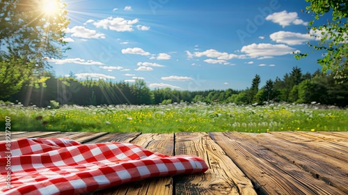 Fototapeta Naklejka Na Ścianę i Meble -  Wooden Table Overlooking Green Meadow under Blue Sky