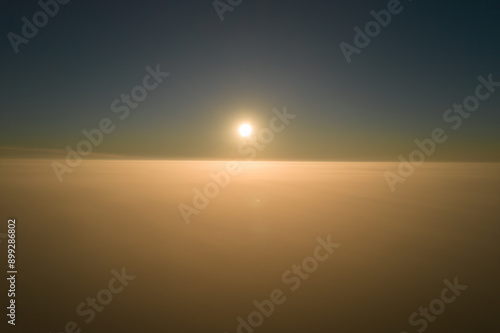 Amazing natural scenery. The camera rises out of the thick fog over a beautiful ocean of clouds at sunrise.