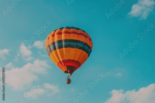 colorful hot air balloon flying on blue sky. adventure © Anna