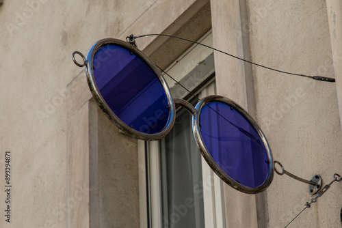 eyeglasses giant logo blue optic sign front of store medical storefront optician glasses photo