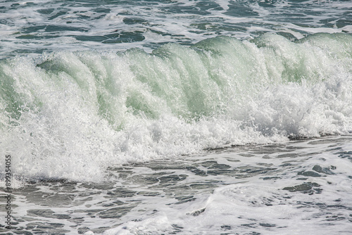 foamy coastal sea wave of a pebble beach