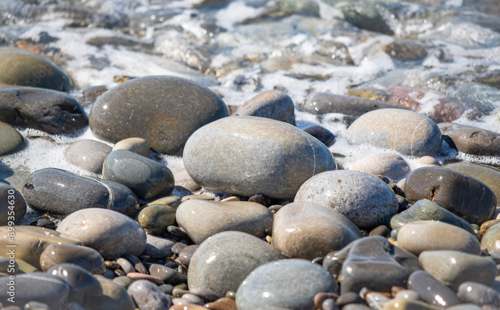 A sea wave breaks against the rocks, water splashes in the sky. Tidal wave. A sea wave breaks against the rocks, water splashes in the sky. Tidal wave.