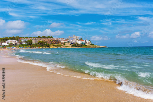 Serene Tarragona Beach Scene with Waves and Coastal Homes