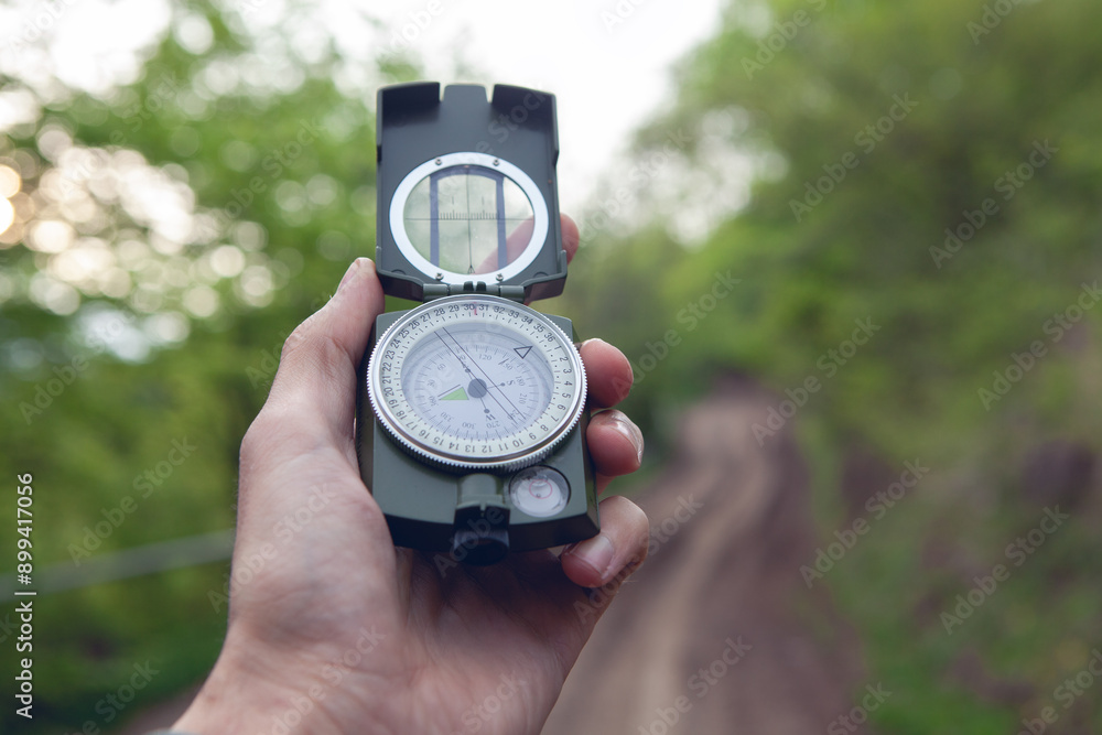 compass in hand of man with blurred background. compass in hand of man with blurred background.