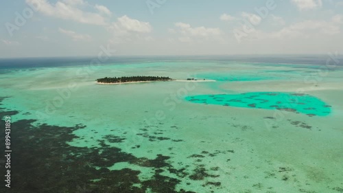 Tropical island in the ocean with palm trees on white sand beach. Onok Island, Balabac, Philippines. Summer and travel vacation concept photo