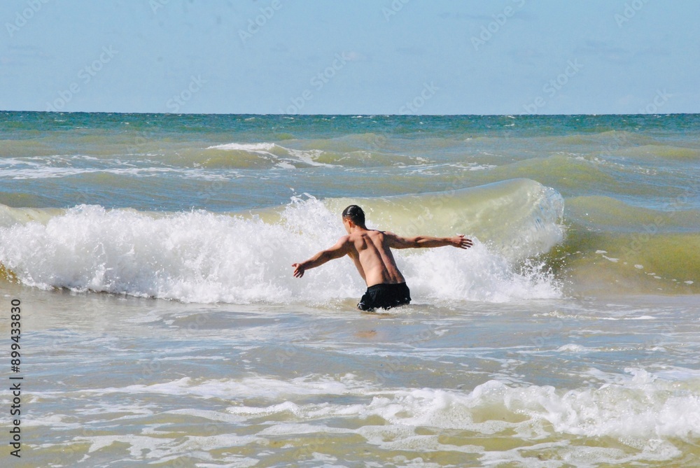 man jumping into a wave man jumping into a wave