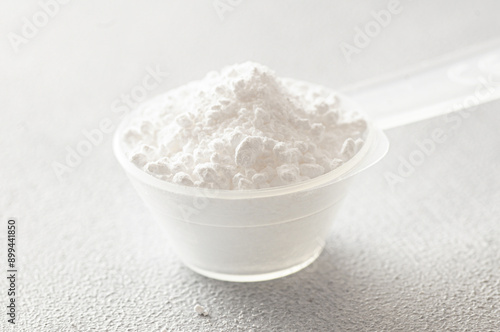 Powdered magnesium oxide or sulfate in a medicine spoon, water soluble drug group photo