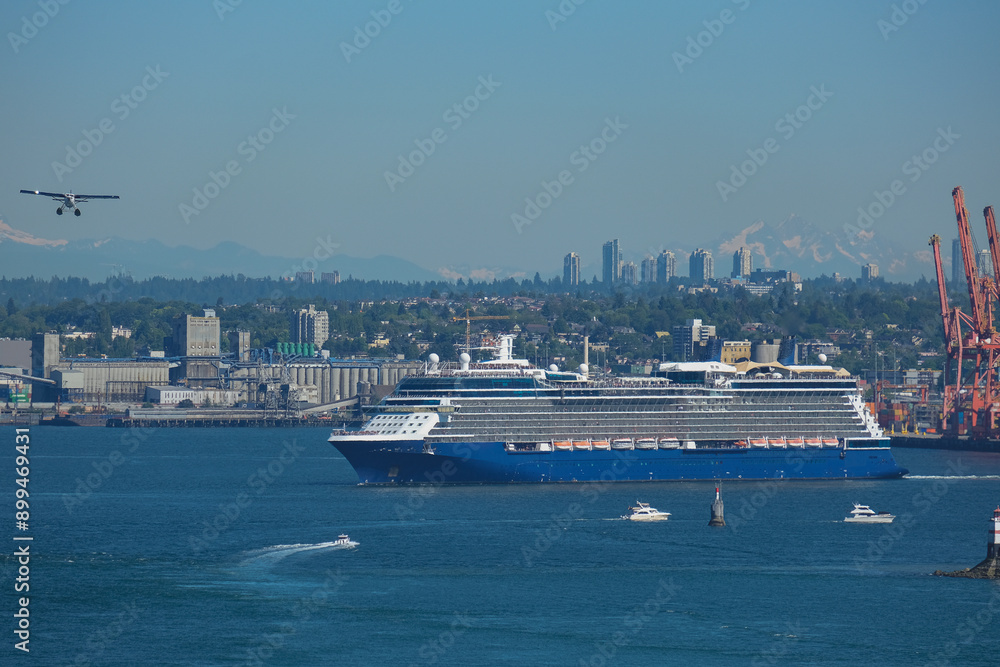 Modern Celebrity cruiseship cruise ship ocean liner sail away departure from port of Vancouver, British Columbia for Alaska summer cruising on sunny day with city skyline Mount Rainier Modern Celebrity cruiseship cruise ship ocean liner sail away departure from port of Vancouver, British Columbia for Alaska summer cruising on sunny day with city skyline Mount Rainier