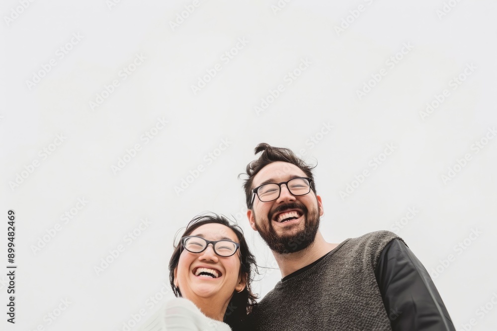 Happy and smiling couple in front of white sky Happy and smiling couple in front of white sky