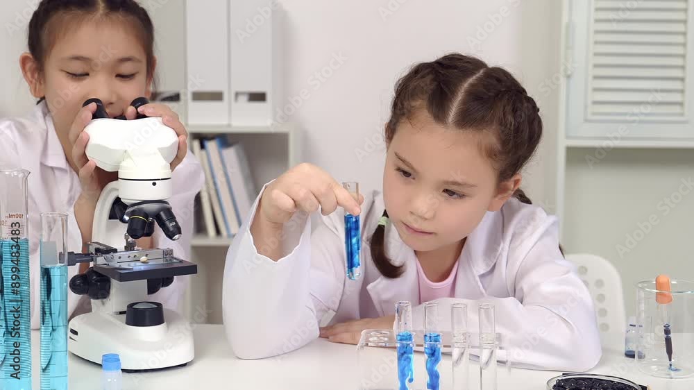 Chemistry, science and children with liquid for research, futuristic innovation or project at international school young girl and friend scientist doing scientific experiment Chemistry, science and children with liquid for research, futuristic innovation or project at international school young girl and friend scientist doing scientific experiment