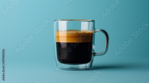 A cup of coffee sits on a wooden table