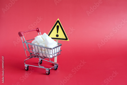 A basket filled with sugar cubes, a close-up and a warning sign 