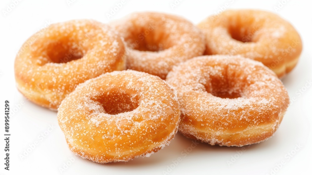 Variety of scrumptious sugar donuts are arranged neatly on a clean white background, tempting you with their deliciousness Variety of scrumptious sugar donuts are arranged neatly on a clean white background, tempting you with their deliciousness