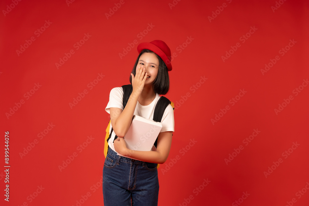 A cute and confident Asian female student poses for a photo against a red background in a studio, a testament to the transformative power of education and her unwavering pursuit of knowledge. A cute and confident Asian female student poses for a photo against a red background in a studio, a testament to the transformative power of education and her unwavering pursuit of knowledge.