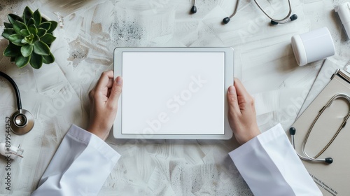 Male doctor holding tablet on table