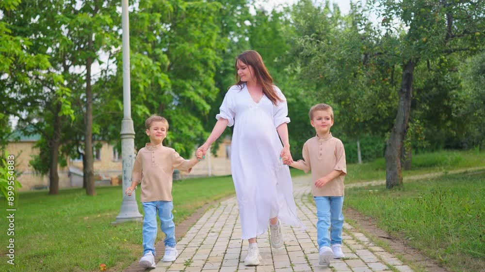 Young Family Picnic Pregnant Mom white dress and Twins.Happy pregnant mom smiles and walks in the park with twins. Green grass and trees. Happy family enjoying summer holidays.
Happy Mom Smile. Young Family Picnic Pregnant Mom white dress and Twins.Happy pregnant mom smiles and walks in the park with twins. Green grass and trees. Happy family enjoying summer holidays.
Happy Mom Smile.