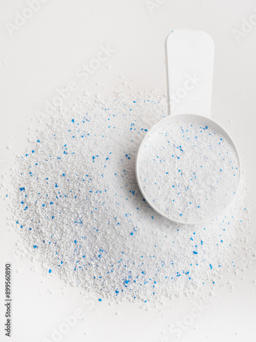 washing powder with a special spoon on a white background