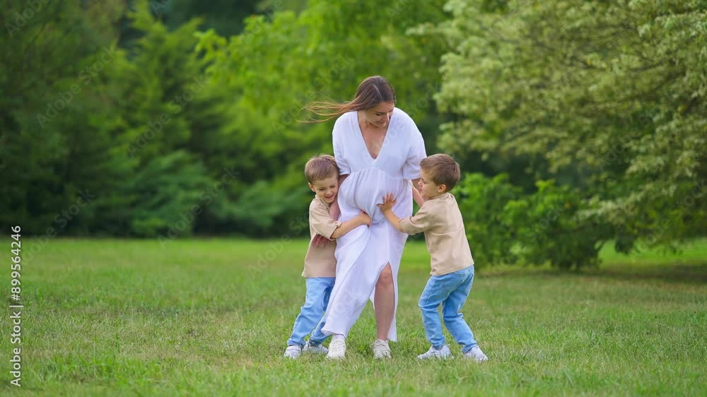 Young Family Picnic Pregnant Mom white dress and Twins.Happy pregnant mom smiles and walks in the park with twins. Green grass and trees. Happy family enjoying summer holidays.
Happy Mom Smile. Young Family Picnic Pregnant Mom white dress and Twins.Happy pregnant mom smiles and walks in the park with twins. Green grass and trees. Happy family enjoying summer holidays.
Happy Mom Smile.