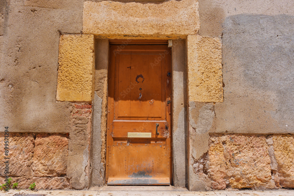 Weathered Wooden Door Set In Textured Stone Wall Weathered Wooden Door Set In Textured Stone Wall