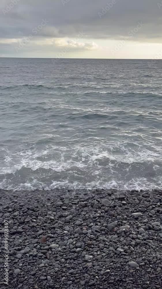 Volcanic beach with waves rolling in Volcanic beach with waves rolling in