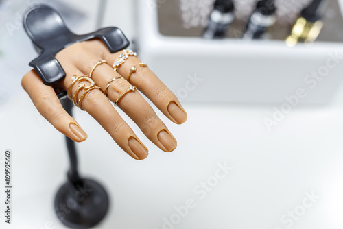 Female lifesize realistic silicone practice hand model in a nail salon with Bracket Stand photo