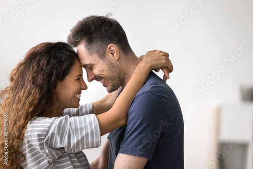 Obraz na plátně Close up side view beautiful Hispanic loving couple, embracing, enjoy moment of tenderness and strong emotional connection