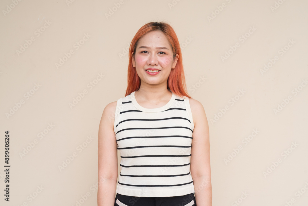 Obraz premium Portrait of Beautiful Asian Woman Smiling Against Plain Background