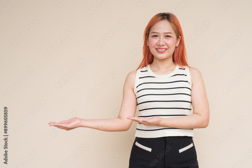 Portrait of Beautiful Asian Woman Showing Copyspace Against Plain Background Portrait of Beautiful Asian Woman Showing Copyspace Against Plain Background