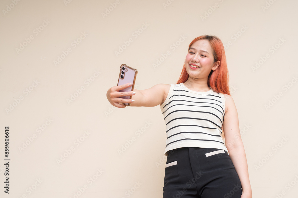 Portrait of Beautiful Asian Woman Using Phone Taking Selfie Against Plain Background Portrait of Beautiful Asian Woman Using Phone Taking Selfie Against Plain Background