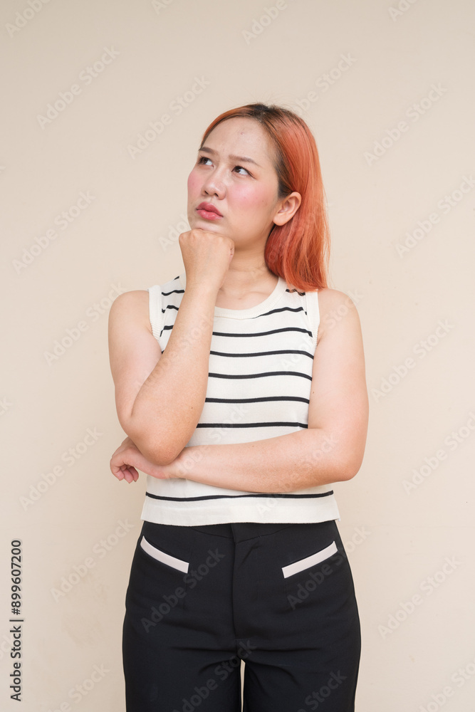Portrait of Beautiful Asian Woman Thinking Against Plain Background Portrait of Beautiful Asian Woman Thinking Against Plain Background