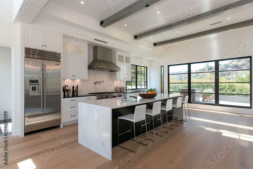 Modern White Kitchen with Large Windows, High-End Appliances, and Sleek Design 