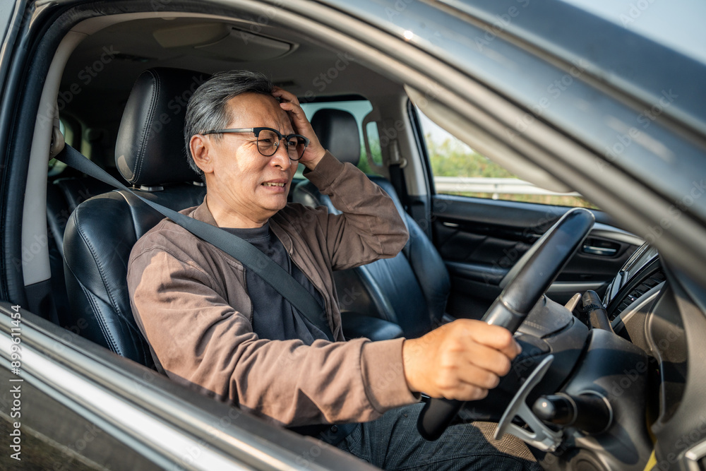 Senior asian man has broken down car on the road he feeling serious and stressed. Look for someone help. Mature Driving during rush hour But the traffic is very congested. Shocked face Senior asian man has broken down car on the road he feeling serious and stressed. Look for someone help. Mature Driving during rush hour But the traffic is very congested. Shocked face