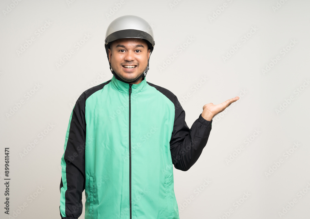 Young asian rider wearing green jacket uniform and helmet standing various action on isolated white background. Male delivery service worker. Delivery courier and shipping food service. Young asian rider wearing green jacket uniform and helmet standing various action on isolated white background. Male delivery service worker. Delivery courier and shipping food service.