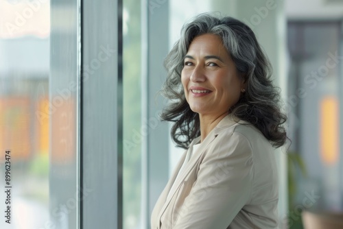 Free Download Latin mature businesswoman in office  thinking of new ideas. - GFXLoad