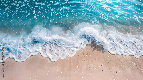 Overhead photo of crashing waves on the shoreline beach. Tropical beach surf. Abstract aerial ocean view