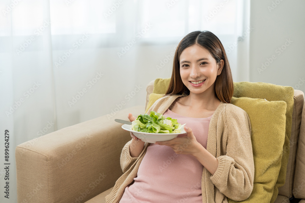 Happy pregnant woman eating vegetable salad and smiling to camera, concept of healthy mother taking health care and nourish her fetal and waiting her childbirth. Happy pregnant woman eating vegetable salad and smiling to camera, concept of healthy mother taking health care and nourish her fetal and waiting her childbirth.