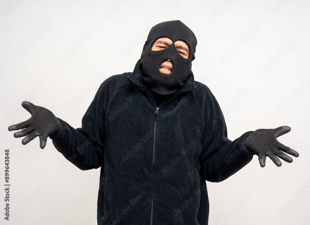 Thief in uniform black jacket various pose on isolated background. The Robber terrorism criminal escapes with balaclava and crowbar entering a house for stealing Housebreak Thief in uniform black jacket various pose on isolated background. The Robber terrorism criminal escapes with balaclava and crowbar entering a house for stealing Housebreak