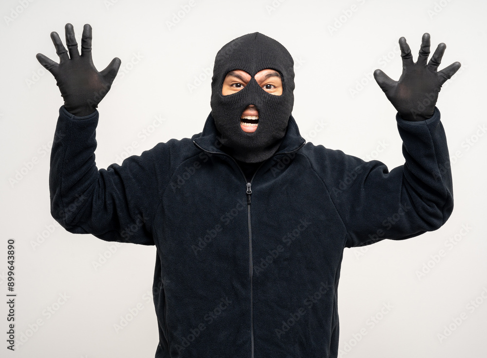 Thief in uniform black jacket various pose on isolated background. The Robber terrorism criminal escapes with balaclava and crowbar entering a house for stealing Housebreak Thief in uniform black jacket various pose on isolated background. The Robber terrorism criminal escapes with balaclava and crowbar entering a house for stealing Housebreak
