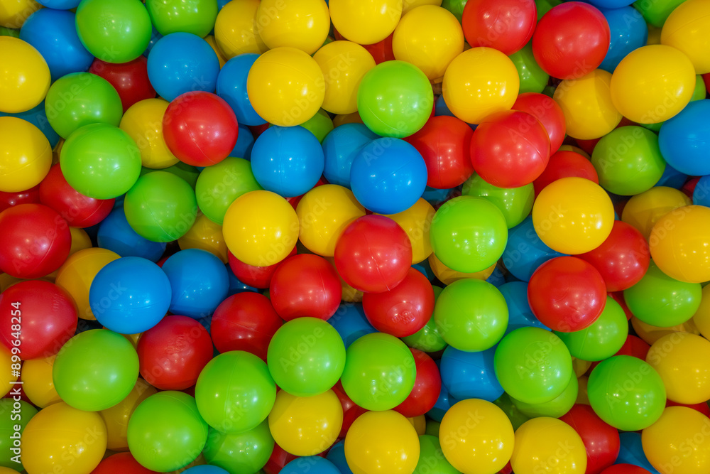 Colorful plastic balls in a children's playroom, top view Colorful plastic balls in a children's playroom, top view