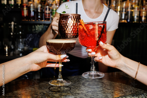 Photography Girls celebrating with cocktails aperol spritz, Moscow mule, coffee spritz, clos
