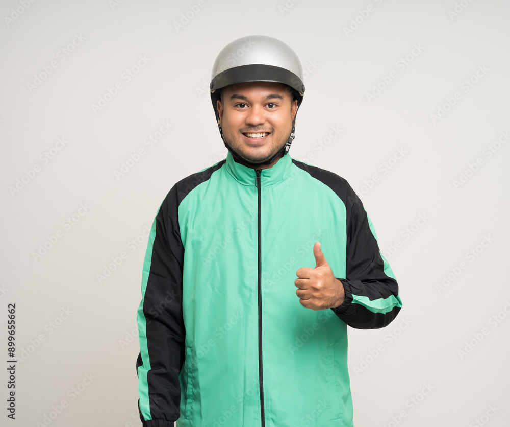 Young asian rider wearing green jacket uniform and helmet standing various action on isolated white background. Male delivery service worker. Delivery courier and shipping food service. Young asian rider wearing green jacket uniform and helmet standing various action on isolated white background. Male delivery service worker. Delivery courier and shipping food service.